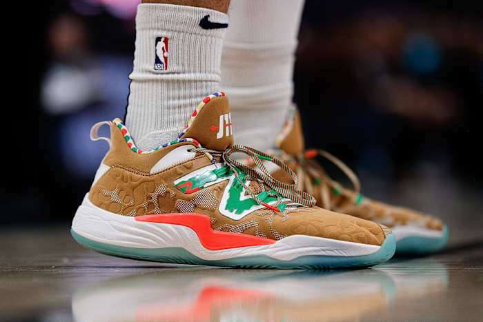 View of brown and green New Balance shoes.